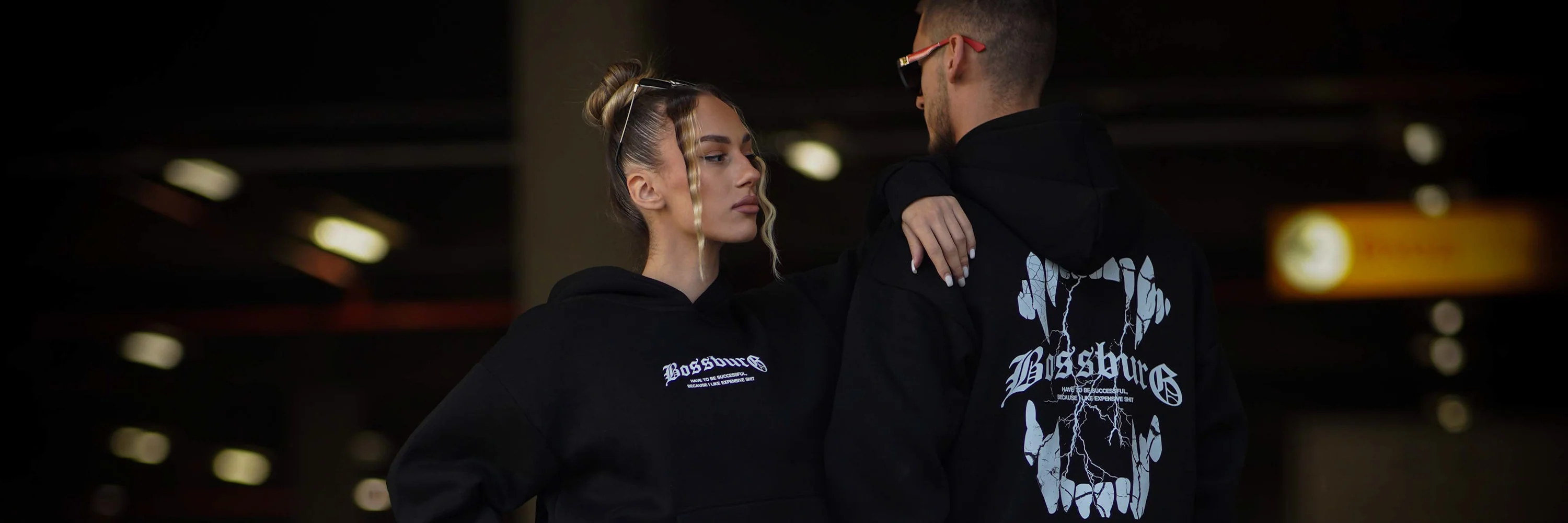 a boy and girl posing in black streetwear hoodie